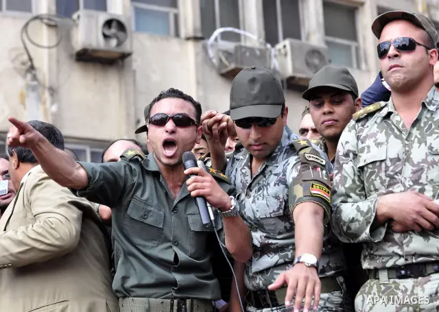 Egyptian officers take part in a protest calling the Field Marshal Hussein Tantawi to step down in Cairo's central Tahrir Square, the focal point of Egyptian uprising, during a protest demanding prosecution of Mubarak an...