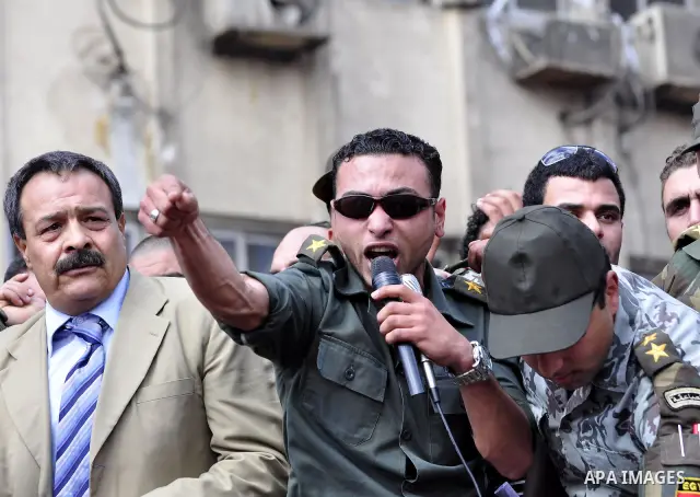 Egyptian officers take part in a protest calling the Field Marshal Hussein Tantawi to step down in Cairo's central Tahrir Square, the focal point of Egyptian uprising, during a protest demanding prosecution of Mubarak an...