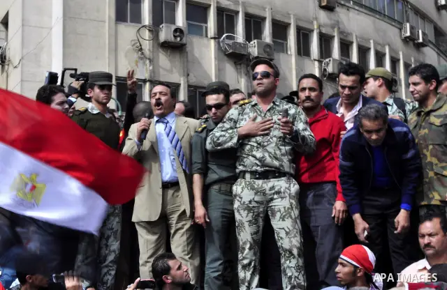 Egyptian officers take part in a protest calling the Field Marshal Hussein Tantawi to step down in Cairo's central Tahrir Square, the focal point of Egyptian uprising, during a protest demanding prosecution of Mubarak an...