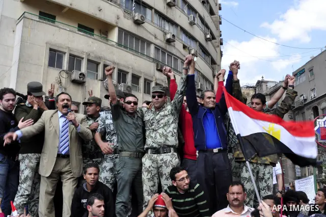 Egyptian officers take part in a protest calling the Field Marshal Hussein Tantawi to step down in Cairo's central Tahrir Square, the focal point of Egyptian uprising, during a protest demanding prosecution of Mubarak an...