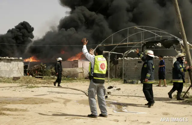 Palestinians try to extinguish an accidental fire that swept over a smuggling tunnel in the southern Gaza Strip town of Rafah on the border with Egypt on April 8, 2011. Tunnels under the town of Rafah that straddles the...