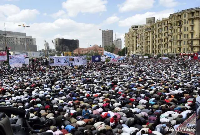 Egyptians perform Friday prayers as tens of thousands gathered for a demonstration at Cairo's Tahrir Square on April 8, 2011, two months after president Hosni Mubarak was ousted, to demand that former regime officials in...