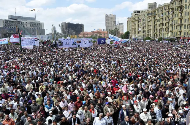 Egyptians perform Friday prayers as tens of thousands gathered for a demonstration at Cairo's Tahrir Square on April 8, 2011, two months after president Hosni Mubarak was ousted, to demand that former regime officials in...