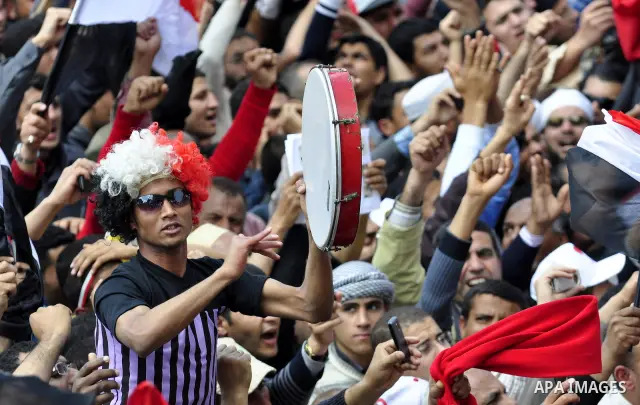 Egyptians hold flags and shout slogans as tens of thousands gathered for a demonstration at Cairo's Tahrir Square on April 8, 2011, two months after president Hosni Mubarak was ousted, to demand that former regime offici...