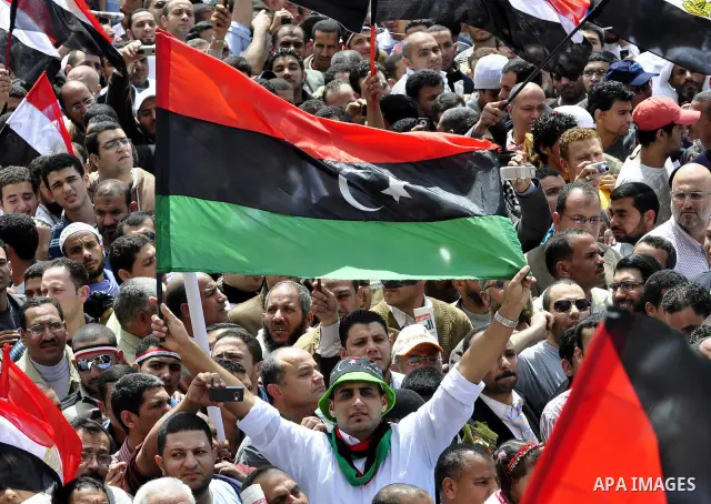 Egyptians hold flags and shout slogans as tens of thousands gathered for a demonstration at Cairo's Tahrir Square on April 8, 2011, two months after president Hosni Mubarak was ousted, to demand that former regime offici...