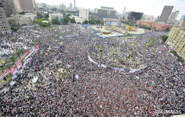 Egyptians hold flags and shout slogans as tens of thousands gathered for a demonstration at Cairo's Tahrir Square on April 8, 2011, two months after president Hosni Mubarak was ousted, to demand that former regime offici...