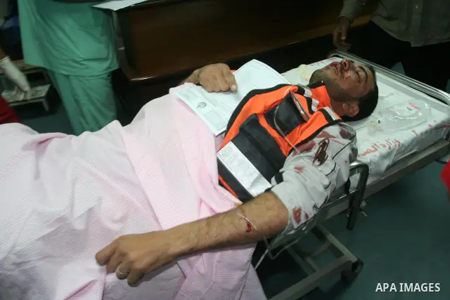 Medics rush a wounded Palestinian man into a hospital in Gaza City on April 8, 2011 following Israeli shelling in which two Palestinians were killed and 10 people wounded, including some children. Photo by Mohammed Asad