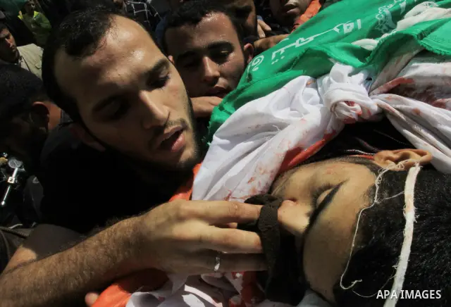 Mourners carry the body of Hamas militant Ahmed Zaitonia during his funeral in Gaza City, April 9, 2011. as the Israeli army pounded the Gaza Strip, killing at least 12 people as militants fired dozens of mortar rounds a...