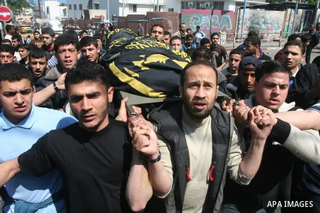 Mourners carry the body of Islamic Jehad militant Belal El-Araer during his funeral in Gaza City, April 9, 2011. as the Israeli army pounded the Gaza Strip, killing at least 12 people as militants fired dozens of mortar...