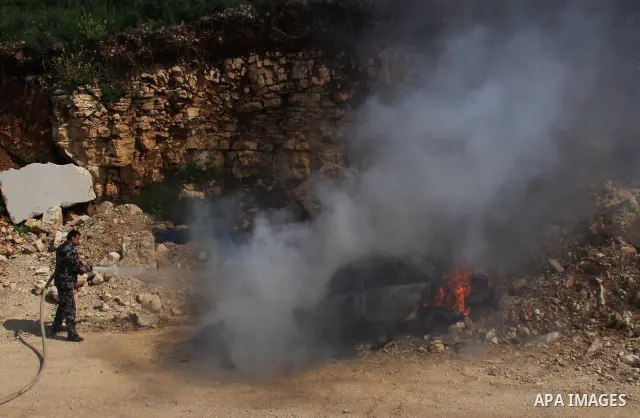 A Palestinian firefighter extinguishes a burning vehicle which residents said was torched by Jewish settlers in the West Bank village of Aseera, Saturday, April 9, 2011. Palestinian witnesses said about 40 settlers enter...