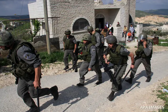 Israeli troops arrive to break up a scuffle between Jewish settlers and Palestinians in the West Bank village of Aseera, Saturday, April 9, 2011. Palestinian witnesses said about 40 settlers entered the village and scuff...