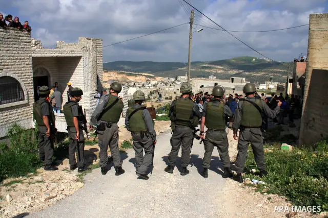 Israeli troops arrive to break up a scuffle between Jewish settlers and Palestinians in the West Bank village of Aseera, Saturday, April 9, 2011. Palestinian witnesses said about 40 settlers entered the village and scuff...