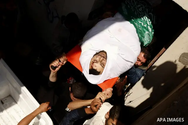 Palestinian mourners carry the body of Hamas militant Mohammed Awaja during his funeral in Rafah in the southern Gaza Strip on April 9, 2011 as the Israeli army pounded the Gaza Strip, killing at least 12 people while mi...