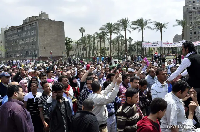 Protesters chant slogans as they march following an attack by security forces in Tahrir Square, in Cairo, Egypt, Saturday, April 9, 2011. Demonstrators burned cars and barricaded themselves with barbed wire inside a cent...