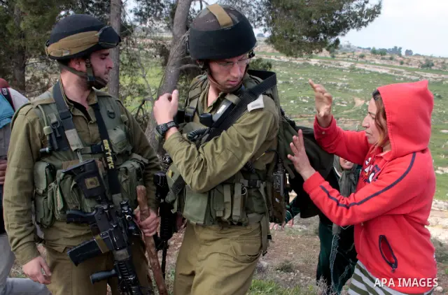 A Palestinian demonstrator argues with an Israeli soldier during a protest against Israel's controversial separation barrier organized by Palestinian and foreign peace activists in the West Bank village of Safa, near Heb...