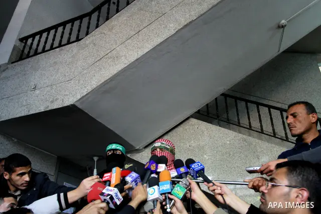 The spokesman of Ezzedine al-Qassam Brigade, the military wing of the Palestinian Islamist movement Hamas which rules Gaza, Abo Obeda gives a press conference in Gaza City on April 9, 2011, as Israeli tank fire killed a...