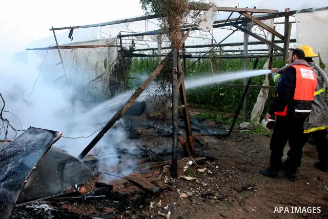 Members of civil defence try to stop fire in a Hut after an Israeli air strike in gaza city. as the Israeli army pounded the Gaza Strip, killing at least 12 people as militants fired dozens of mortar rounds and rockets i...