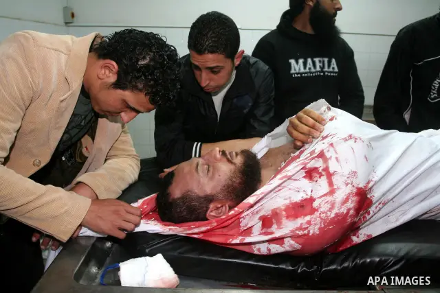 Palestinian relatives gather around the body of Raed El-Bor at the morgue of AL-shifa hospital in Gaza city, April 9, 2011.The Israeli army pounded the Gaza Strip, killing at least 18 people while militants fired dozens...