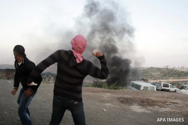 Palestinian youths hurl stones towards Israeli soldiers during clashes in the most Arab neighbourhood of Issawiah in Jerusalem on April 9,2011. Photo by Mahfouz Abu Turk