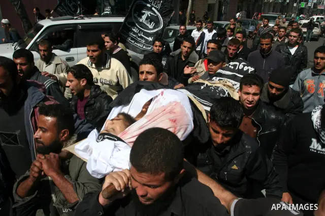 Palestinians carry the body of Popular Resistance Committees militant Raed Al-Bar during his funeral in Gaza City April 10, 2011. Al-Bar was killed in an Israeli air strike on Saturday. Palestinian militant groups in the...
