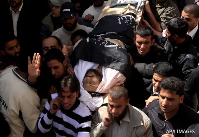 Palestinians carry the body of Popular Resistance Committees militant Raed Al-Bar during his funeral in Gaza City April 10, 2011. Al-Bar was killed in an Israeli air strike on Saturday. Palestinian militant groups in the...