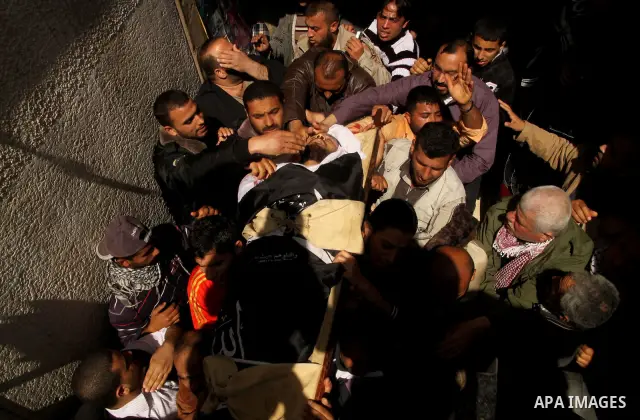 Palestinians carry the body of Popular Resistance Committees militant Raed Al-Bar during his funeral in Gaza City April 10, 2011. Al-Bar was killed in an Israeli air strike on Saturday. Palestinian militant groups in the...
