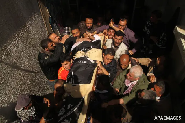 Palestinians carry the body of Popular Resistance Committees militant Raed Al-Bar during his funeral in Gaza City April 10, 2011. Al-Bar was killed in an Israeli air strike on Saturday. Palestinian militant groups in the...