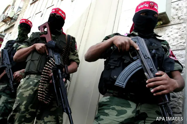 Palestinian militants of the National Resistance Brigades, the military wing of the Democratic Front for the Liberation of Palestine (DFLP), attend a news conference in the central Gaza City, 10 April 2011. Israel will c...