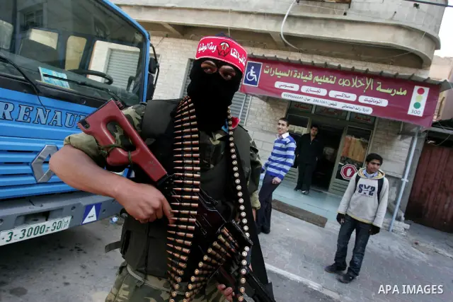 Palestinian militants of the National Resistance Brigades, the military wing of the Democratic Front for the Liberation of Palestine (DFLP), attend a news conference in the central Gaza City, 10 April 2011. Israel will c...