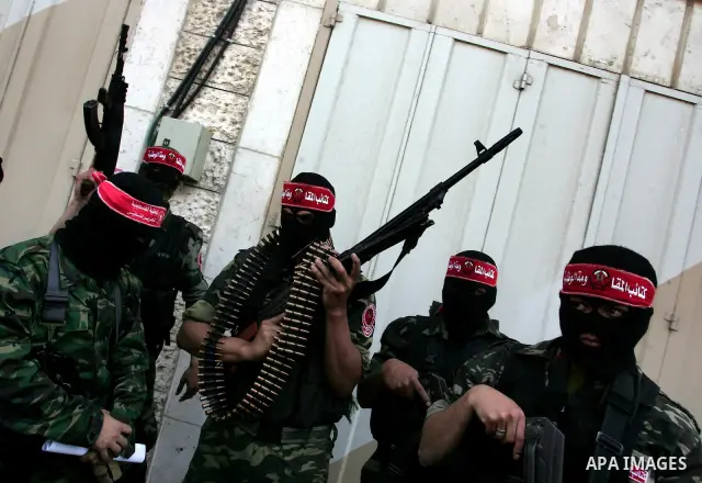 Palestinian militants of the National Resistance Brigades, the military wing of the Democratic Front for the Liberation of Palestine (DFLP), attend a news conference in the central Gaza City, 10 April 2011. Israel will c...