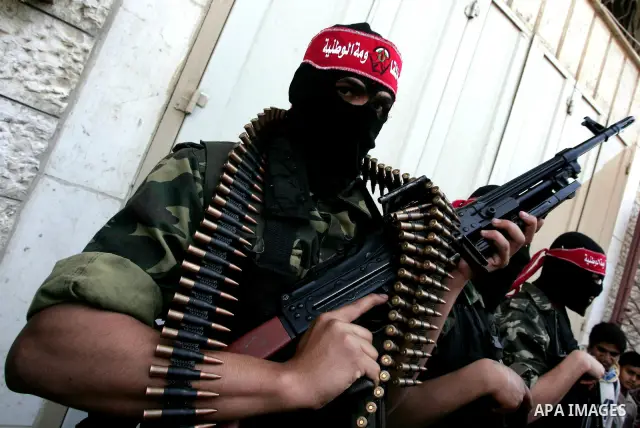 Palestinian militants of the National Resistance Brigades, the military wing of the Democratic Front for the Liberation of Palestine (DFLP), attend a news conference in the central Gaza City, 10 April 2011. Israel will c...