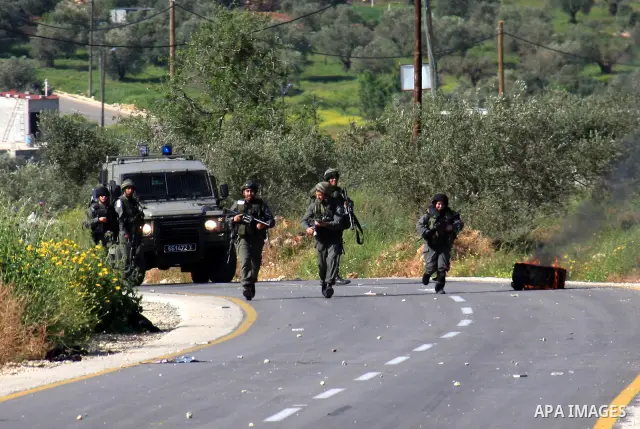 Israeli border policemen run towards Palestinian stone-throwers during clashes outside the West Bank Palestinian village of Awarta near the West Bank city of Nablus, Sunday, April 10, 2011. The Israeli army often carries...