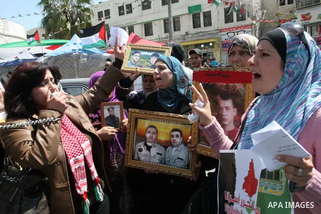 Palestinian women hold pictures of relatives during a protest calling for the release of Palestinian prisoners from Israeli jails, in the West Bank city of Nablus , Sunday, April 10, 2011. Israel currently holds about 8,...