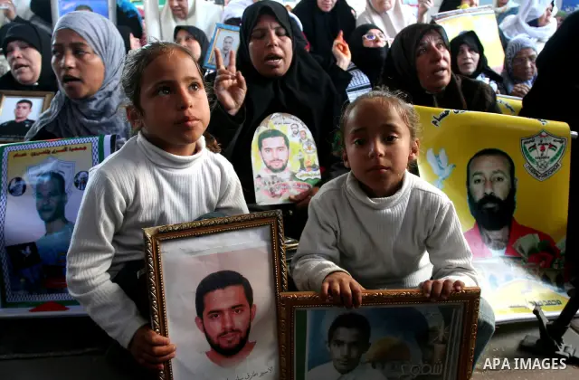 Palestinians hold pictures of jailed relatives during a protest in Gaza city calling for their release from Israeli prisons on April 11, 2011. Photo by Mohamad Asad