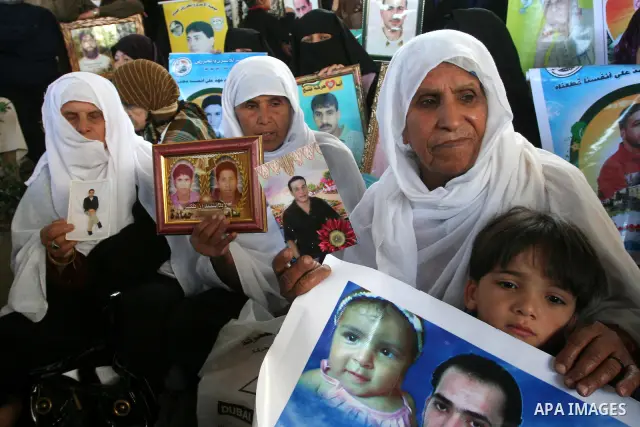 Palestinians hold pictures of jailed relatives during a protest in Gaza city calling for their release from Israeli prisons on April 11, 2011. Photo by Mohamad Asad