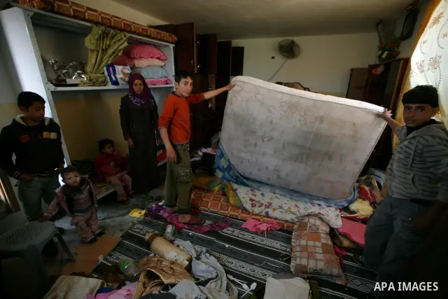 Palestinians inspect damage in their house in the West Bank village of Awarta near Nablus April 11, 2011, which they say was caused by an Israeli army raid. The Israeli army often carries out raids in West Bank towns and...