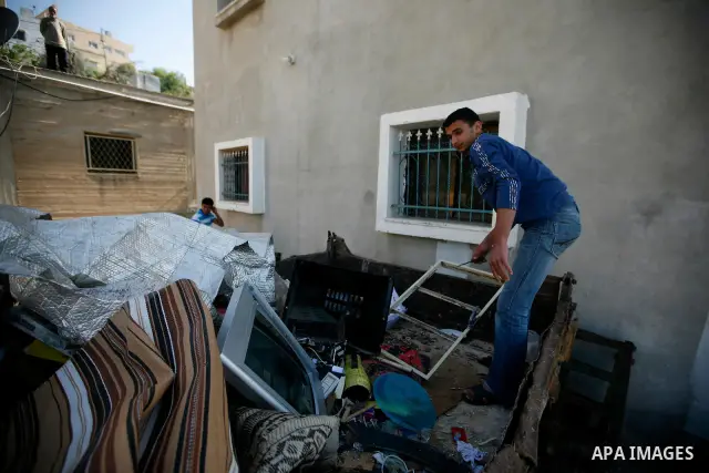 Palestinians inspect damage in their house in the West Bank village of Awarta near Nablus April 11, 2011, which they say was caused by an Israeli army raid. The Israeli army often carries out raids in West Bank towns and...