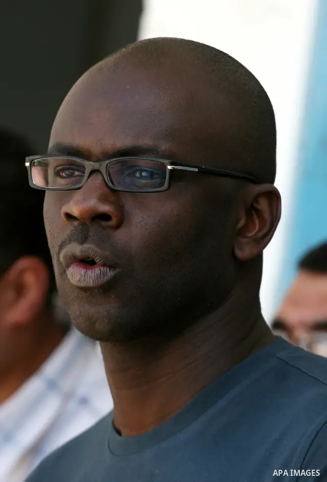 Former French soccer player Lilian Thuram visits a school in the West bank refugee camp of Kalandia, on 11 April 2011. Thuram is visiting the Palestinian territory in support of the education programme funded by France t...