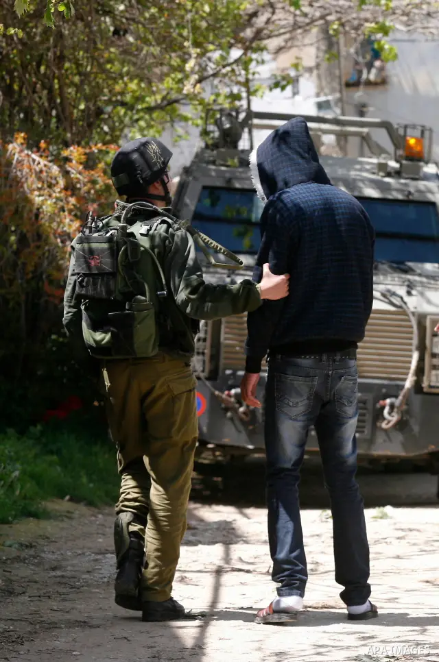 Palestinian man during a military operation searching for suspects during a curfew in the West Bank village of Awarta, near Nablus City on 12 April 2011 as the northern West Bank village has been the centre of a massive...