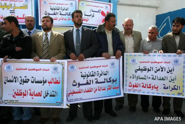 Palestinian UNRWA employees take part in a protest after a work strike extended to three days in Gaza city on April 13,2011 calling the UNRWA to stop the separation of the employees . Photo by Mohammed Asad
