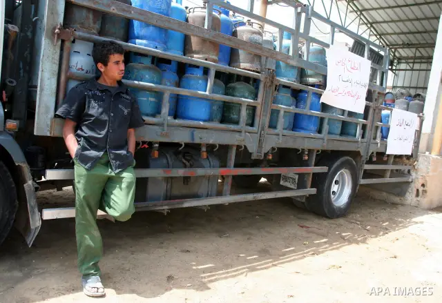 A Palestinian man stands next empty gas canisters at a natural gas station in Gaza city on April 13,2011, as Gaza Strip suffers from the shortage of natural gas which enter to enclave Strip from Israel. Photo by Mohammed...