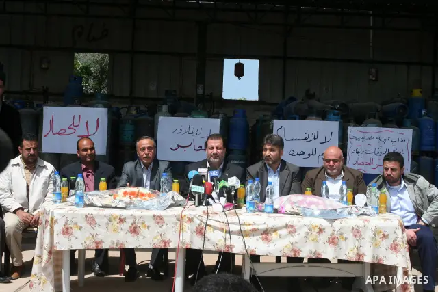 Palestinian members of the Ministry of National Economic attend a press conference next empty gas canisters at a natural gas station in Gaza city on April 13,2011, as Gaza Strip suffers from the shortage of natural gas w...
