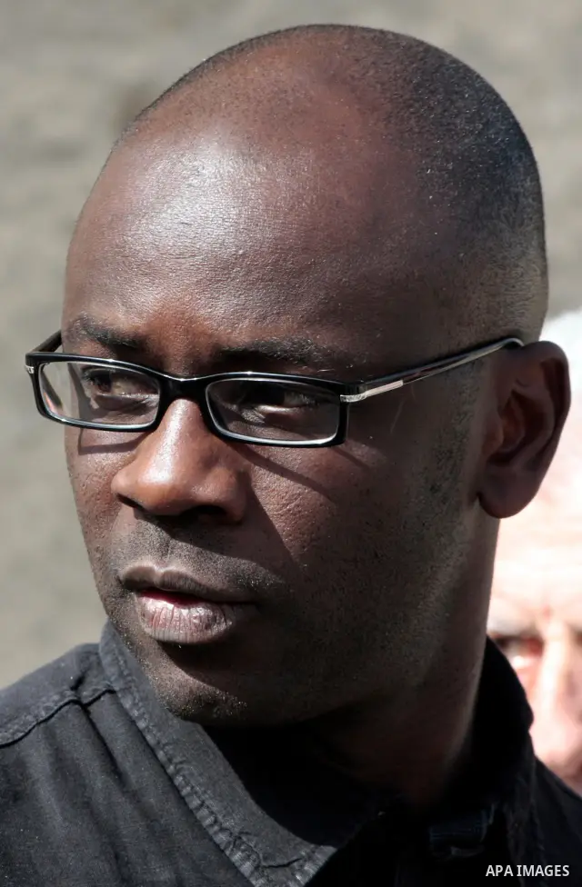 Former French football player Lilian Thuram looks on during a visit to the divided city of Hebron, in the Israeli-occupied West Bank, on April 13, 2011. Thuram is visiting the Palestinian territories in support of the ed...