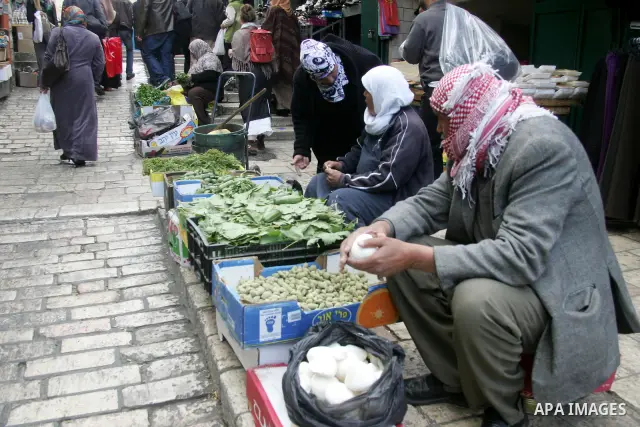 Palestinians shop at the main market in the old city of Jerusalem on April 13, 2011. Photo by Mahfouz Abu Turk