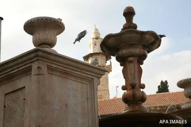 Doves fly over the mosque of Omar Ibn al-Kattab near the Church of the Holy Sepulchre (resurrection) in Jerusalem's Old City on April 13, 2011. Photo by Sliman Khader