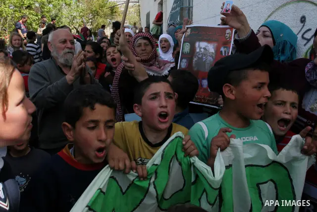 Palestinians protest against the Israeli army's detention of Juliana Awad in the West Bank village of Awarta near Nablus, Thursday, April 14, 2011. Palestinian residents in Awarta say Awad was detained earlier in the wee...