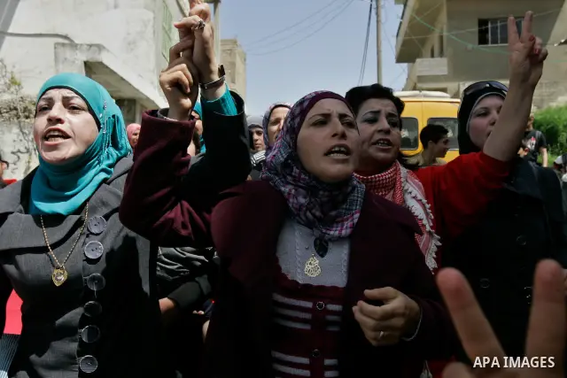 Palestinians protest against the Israeli army's detention of Juliana Awad in the West Bank village of Awarta near Nablus, Thursday, April 14, 2011. Palestinian residents in Awarta say Awad was detained earlier in the wee...