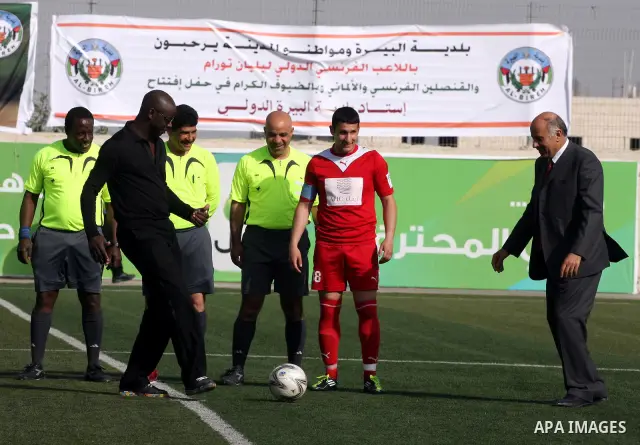 Former French football player Lilian Thuram and the Palestinian Football Association chairman Jibril Rajoub attend the inauguration of a 9,000-capacity stadium, at Al-Bireh, on the outskirts of the West Bank political an...