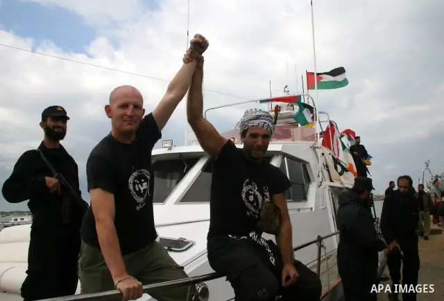This October 29, 2008 file photo shows Italian peace activist Vittorio Arrigoni at the port in Gaza City celebrating the arrival of the 20-metre (65-foot) ship "Dignity" that departed from Cyprus the previous day to prot...