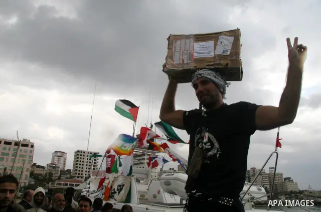 This October 29, 2008 file photo shows Italian peace activist Vittorio Arrigoni at the port in Gaza City celebrating the arrival of the 20-metre (65-foot) ship "Dignity" that departed from Cyprus the previous day to prot...